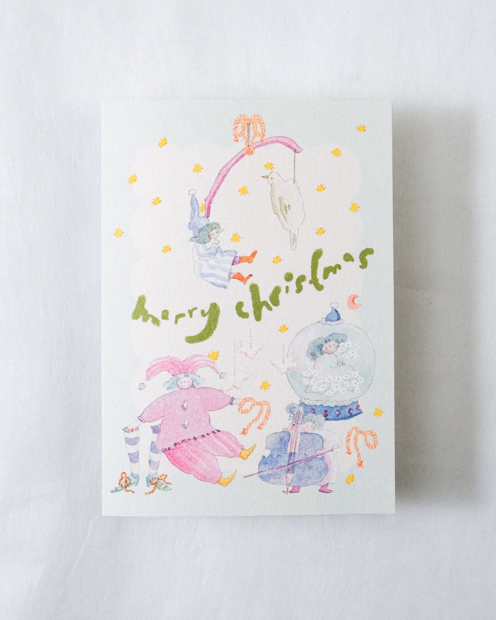 Christmas-themed card with elves and a snow globe on a white background